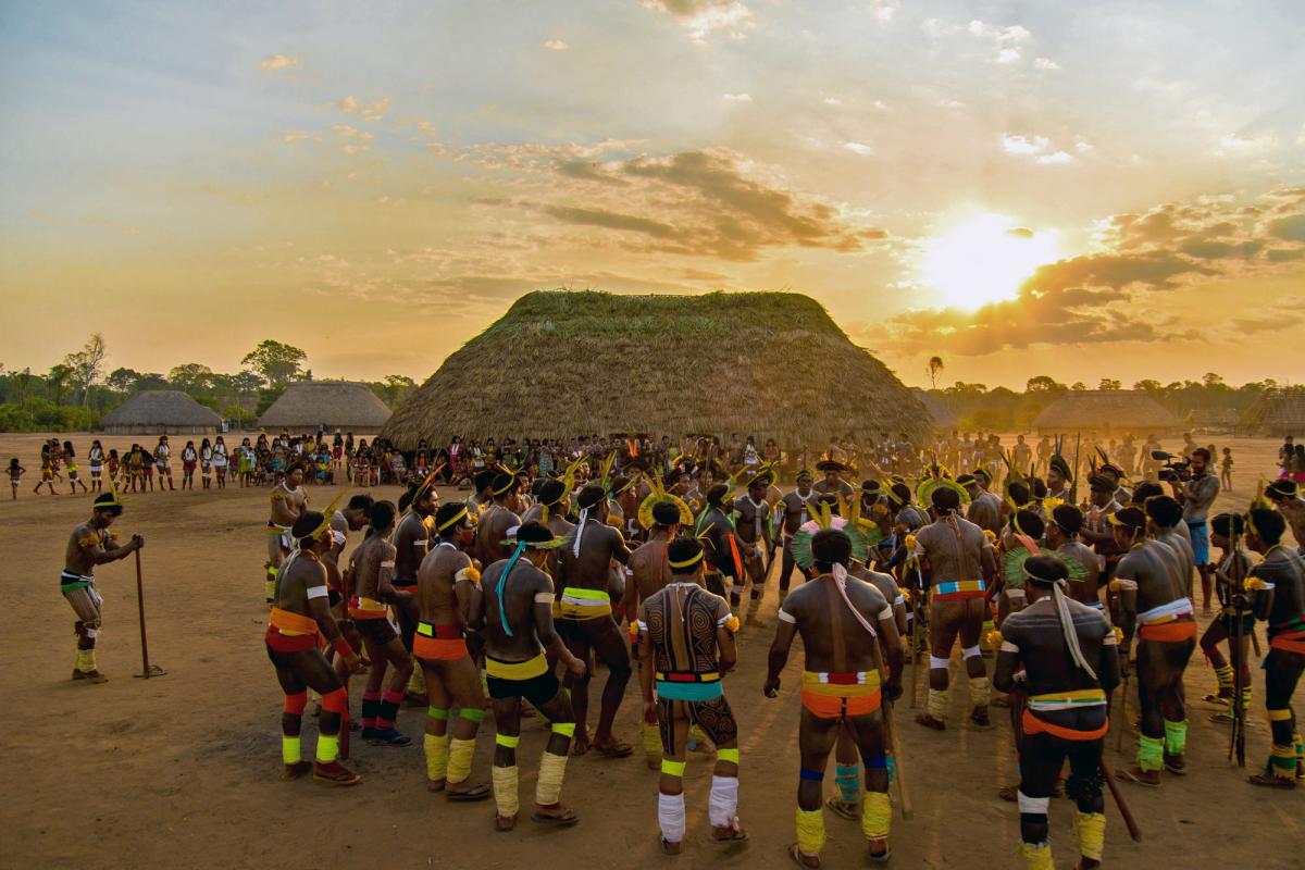 Imagem mostra povo Kisedje reunido em torno de sua casa