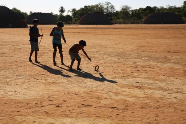 Na Aldeia Kalapalo, crianças se divertem com o ‘ta’, brincadeira tradicional que consiste em tentar acertar o centro de uma roda em movimento utilizando arco e flecha|Tauana Kalapalo/2017